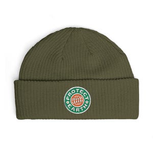May include: An olive green beanie hat with a turned-up brim. The front displays a circular embroidered patch with the words "PROTECT EARTH" encircling a globe graphic in green, white, and orange.