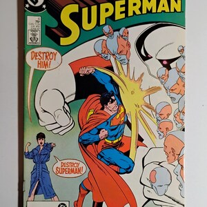 Puede incluir: Una portada de cómic de Superman vintage. Superman aparece en una pose de acción dinámica, con la palabra "Superman" en letras amarillas grandes. La portada incluye el texto "Destroy Him!" y "Destroy Superman!"