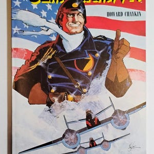 May include: Blackhawk comic book cover featuring a smiling man in a military uniform with an American flag background. The cover art includes illustrations of fighter planes and the text "BLACKHAWK" and "BLOOD & IRON".