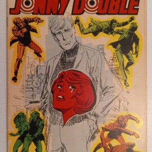 May include: A comic book cover featuring a man with blond hair and a woman with red hair. The cover is titled "Showcase Presents born to TROUBLE... JONNY DOUBLE" and the issue number is 78. The cover is dated November 1965 and costs 12 pence.