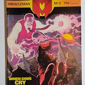 May include: Comic book cover for Miracleman No. 2, featuring a dynamic illustration with a figure in a pink vest emitting energy. The cover includes the title, issue number, and the phrase "When Gods Cry War..."