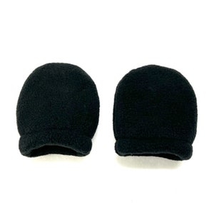 May include: Two black fleece mitten-style hand warmers. The warmers are made of a soft, fuzzy material and have a simple, rounded shape.