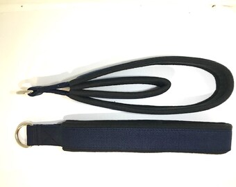 May include: A blue and black dog leash with a metal ring on each end. The leash is made of a soft, padded material.