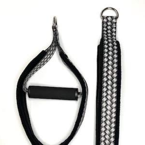 May include: Two black and white patterned exercise straps with a black foam handle. One strap has a loop at the end and the other has a metal ring.