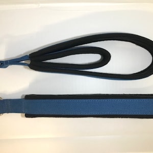 May include: Two blue and black dog leashes with metal rings. The leashes are made of a woven fabric with a black trim.