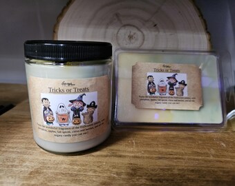 May include: A glass jar candle and a wax melt container with Halloween-themed labels. The labels feature cartoon characters and the text "Tricks or Treats". The candle has a black lid.