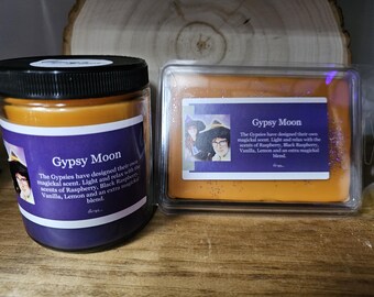 May include: A jar candle and a wax melt, both labeled "Gypsy Moon." The candle is in a glass jar with a black lid and a purple label. The wax melt is in a clear plastic container with a purple label. The labels include text and images.