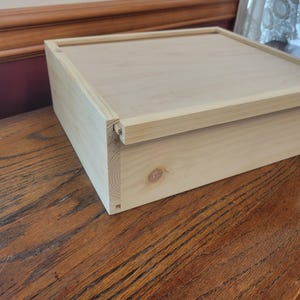 Hidden lid sliding lid box