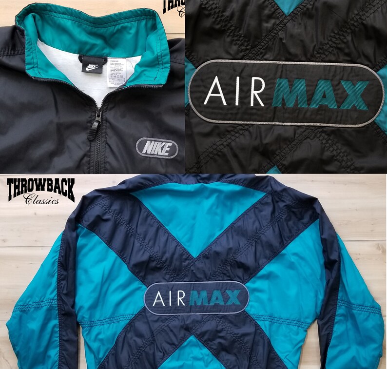May include: Black and teal Nike Air Max windbreaker jacket with a zipper closure and a large Air Max logo on the back. The jacket has a contrasting teal collar and a Nike logo on the left chest.