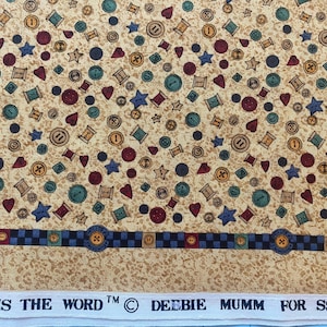 Debbie Mumm fabric with tiny spools hearts buttons and stars scattered on a beige background.