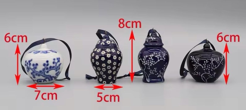 May include: Three blue and white ceramic ornaments with floral designs. The ornaments are 6 cm wide and 7 cm tall, 5 cm wide and 8 cm tall, and 6 cm wide and 8 cm tall.