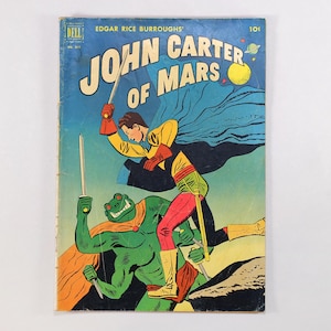 May include: A vintage Dell comic book titled Edgar Rice Burroughs' John Carter of Mars. The cover features a hero in a yellow and red suit wielding a sword against a green, four-armed creature with a cape. The background is a blue sky with planets.