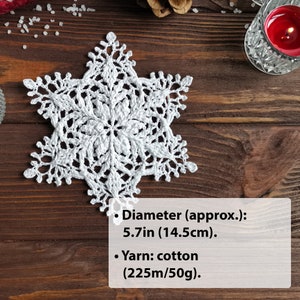 Crocheted snowflake of modern sculptural design, 5.7 inches in diameter and made with cotton yarn.