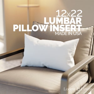 May include: A white lumbar pillow insert in a beige chair. The pillow is 12x22 inches and made in the USA. The text "12x22 Lumbar Pillow Insert Made in USA" is displayed above the pillow.