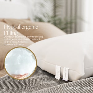 May include: A white pillow with a hypoallergenic poly fiber filling. The pillow is on a bed with a brown and white patterned blanket. The text "Hypoallergenic Filling" is written in black text on a white background. The text "Our down alternative poly fiber filling is allergen and dust mite resistant to give you a healthier, more restful sleep." is written in black text on a white background. The text "Looms & Linens" is written in black text on a white background.