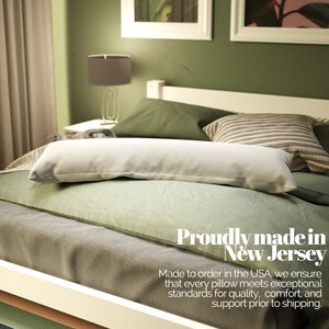 May include: A white body pillow on a bed with green and grey bedding. The text "Proudly made in New Jersey" is displayed below the pillow. The text "Made to order in the USA, we ensure that every pillow meets exceptional standards for quality, comfort, and support prior to shipping." is displayed below the text "Proudly made in New Jersey".