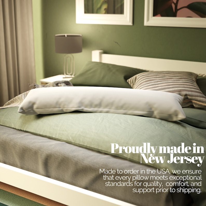 May include: A white body pillow on a bed with green and grey bedding. The text "Proudly made in New Jersey" is displayed below the pillow. The text "Made to order in the USA, we ensure that every pillow meets exceptional standards for quality, comfort, and support prior to shipping." is displayed below the text "Proudly made in New Jersey".