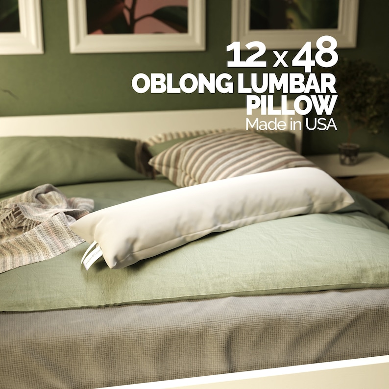 May include: A white oblong lumbar pillow on a green bed with a striped pillow. The pillow is 12 x 48 inches and says "Oblong Lumbar Pillow" and "Made in USA".