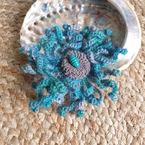 Beautiful brooch: Wild colorful crochet flower in sea colors
