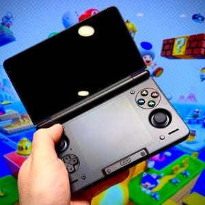 May include: A white ceramic mug with a black handle and the text "But First, Coffee" in a bold, black font. The mug is set against a blurred background, suggesting a cozy setting.