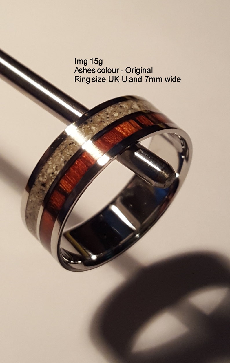 May include: A silver ring with a red and white inlay. The ring is 7mm wide and is size UK U. Img 15g Ashes colour - Original