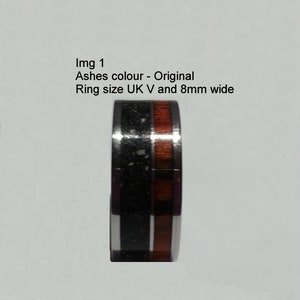 May include: A black and brown ring with a wood inlay. The ring is 8mm wide and size UK V.