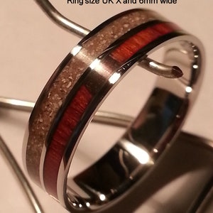 May include: A silver ring with a red and white inlay. The ring is 6mm wide. Img 15f Ashes colour - Original Ring size UK X and 6mm wide