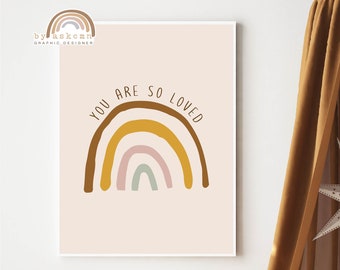 May include: A framed print with a rainbow design and the words "YOU ARE SO LOVED" hangs on a wall. A brown canopy with a star-shaped decoration hangs from the ceiling. A woven basket and toys are on the floor.