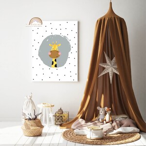 May include: A framed wall art print featuring a cartoon giraffe with a yellow body, brown spots, and a friendly expression. The giraffe is set against a gray circle on a white background with scattered black dots. The room is decorated with a brown canopy, toys, and a woven basket.