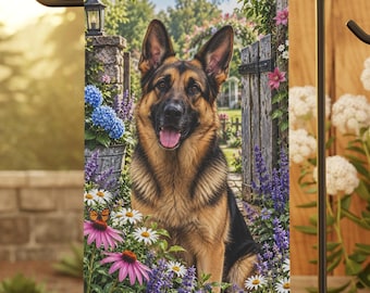 May include: A rectangular garden flag featuring a German Shepherd dog sitting amidst a vibrant flower garden with blue hydrangeas, purple lavender, white daisies, and pink coneflowers, all set against a backdrop of a wooden gate and stone pillar.