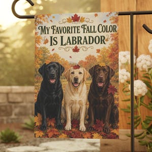 May include: A rectangular garden flag featuring three Labrador retrievers in black, yellow, and chocolate colors sitting among autumn leaves. The text "MY FAVORITE FALL COLOR IS LABRADOR" is printed in dark green letters above the dogs.