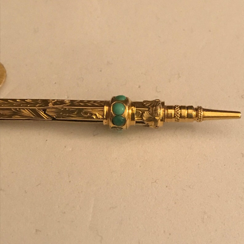 Antique Victorian 9ct Gold Retractable Pencil with seven turquoise stones and smokey quartz end.