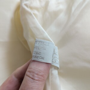 May include: White fabric label with the text "ITALY NYLON 100% RAYON" printed on it.