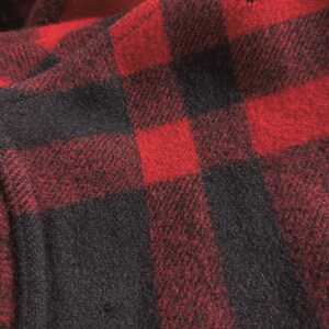 May include: Red and black checked fabric with a soft, fuzzy texture.