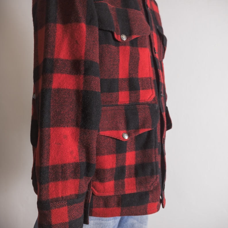 May include: A red and black checked flannel shirt jacket with multiple pockets and silver buttons.