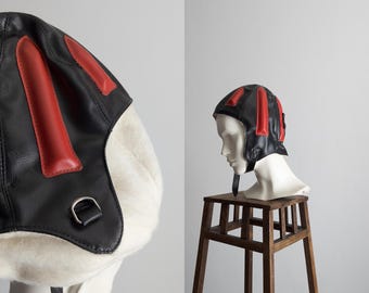 vintage sports helmet black red faux leather with chin strap and goggle loops warm lined interior padded arrow design 1970s–1980s