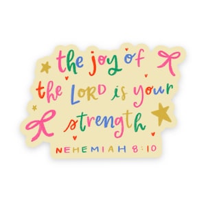 May include: A die-cut sticker with a cream background featuring the colorful handwritten text 'the joy of the LORD is your strength' and 'NEHEMIAH 8:10'. The design includes small gold stars, pink bows, and tiny red hearts.