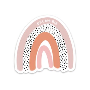 May include: A pink and orange rainbow sticker with black polka dots and the text "DREAM BIG" in white.