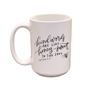 May include: White ceramic mug with a black design that reads "Kind words are like honey-sweet to the soul, Proverbs 16:24". A small bee illustration is to the right of the text.