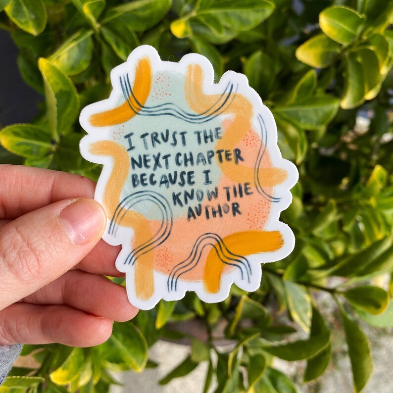 May include: A sticker with a colorful abstract design and the text "I trust the next chapter because I know the author".