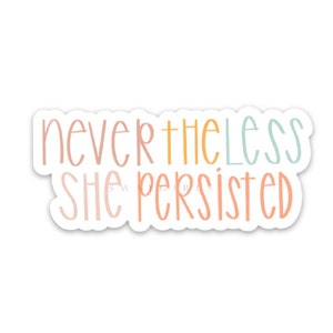 May include: A sticker with the text "nevertheless she persisted" in a colourful, handwritten font. The words "nevertheless" and "she" are in shades of pink and orange, while "persisted" is in a light blue.
