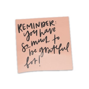 May include: A pink sticky note with the handwritten message "REMINDER: you have so much to be grateful for!"