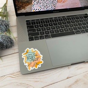 May include: A sticker with a watercolor background and yellow, orange, and blue accents. The sticker features the text "I trust the next chapter because I know the author."