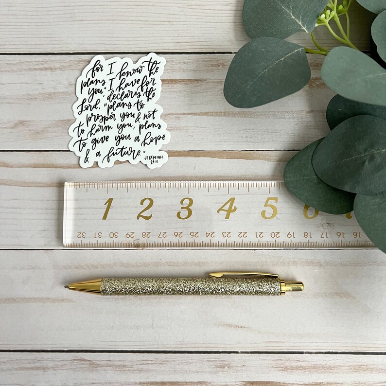 May include: A white sticker with black calligraphy text that reads "for I know the plans I have for you, declares the Lord, "plans to prosper you and not to harm you, plans to give you a hope and a future." Jeremiah 29:11
