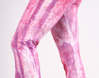 May include: A pair of pink and white tie-dye flared pants. The pants have a loose fit and are made of a soft, comfortable fabric.