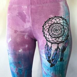 May include: Purple and blue tie-dye leggings with a black dreamcatcher design.