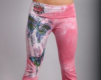 May include: Pink tie-dye yoga pants with a butterfly print. The pants have a wide waistband and a relaxed fit.