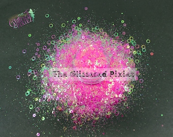 May include: Pink glitter with iridescent holographic circles, a sparkly and colorful craft supply.