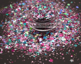 May include: A close-up of a jar filled with pink, teal, and silver glitter. The glitter is a mix of small and large pieces, including stars and hexagons. The jar is labeled "The Glittered Pixie".