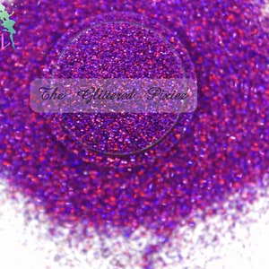 May include: Purple iridescent glitter with a fine texture. The glitter is shown in a small pile on a white background.